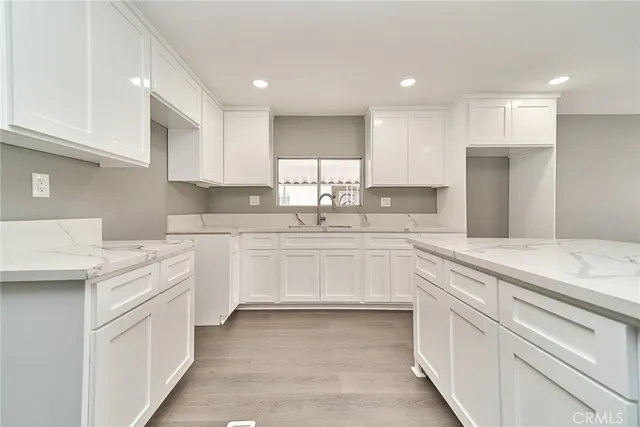 a view of a hallway with wooden floor and closet