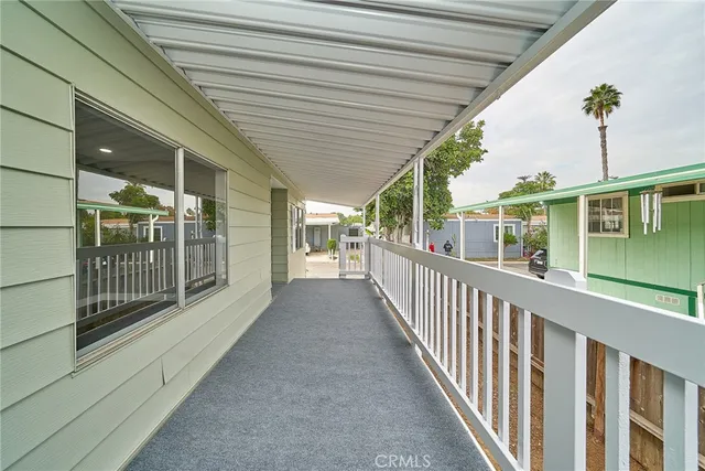 a view of kitchen with kitchen island white cabinets and wooden floor