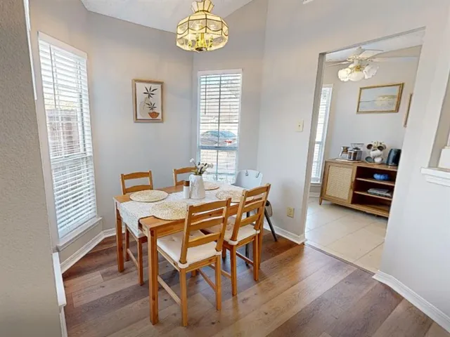 a view of a dining room with furniture and a window