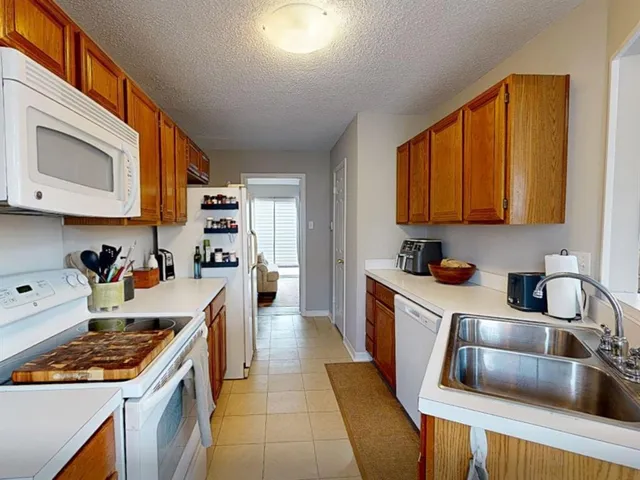 a kitchen with a sink stove top oven and cabinets