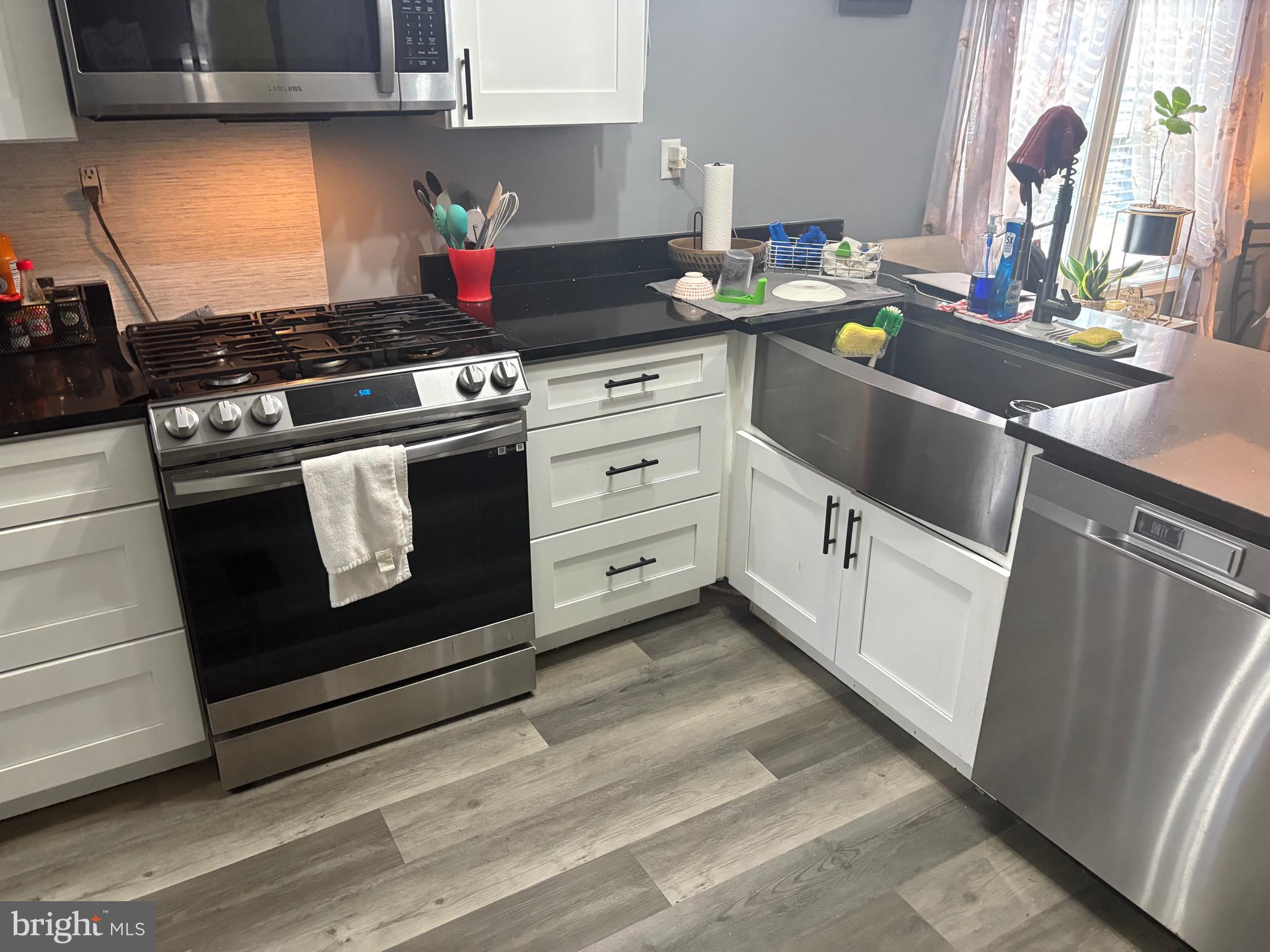3180 Irish Hill Road Magnolia, DE 19962 - Photo 6 of 14 a kitchen with white cabinets and appliances