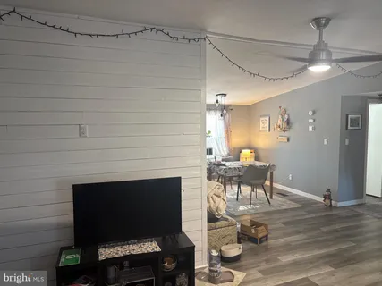 a living room with patio furniture and a fireplace