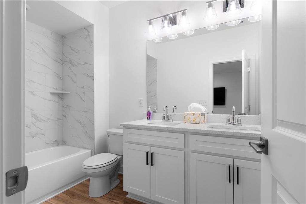 113 Waterview Court Waleska, GA 30183 - Photo 15 of 38 a bathroom with a toilet a sink a tub and mirror