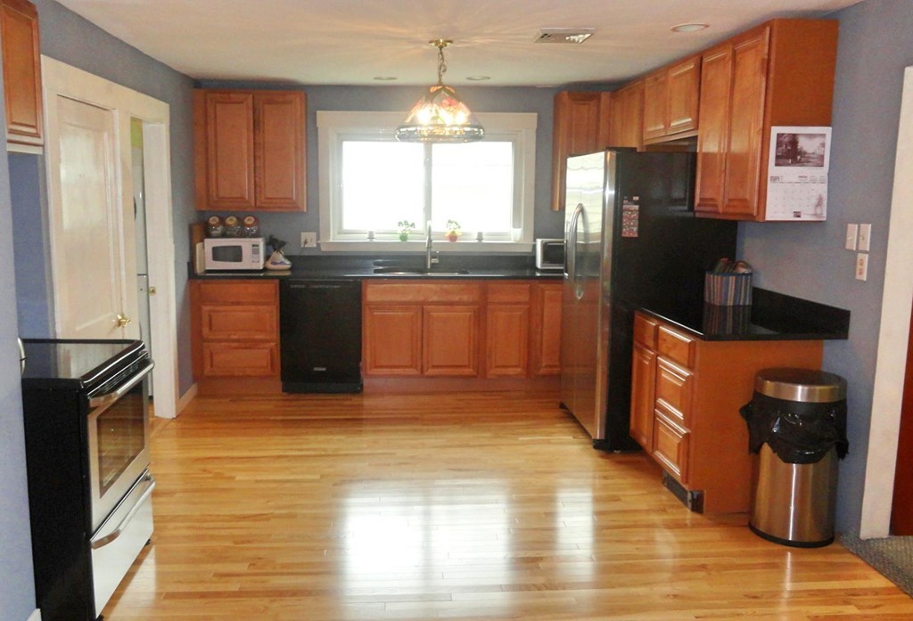 20 North Hunt Road Amesbury, MA 01913 - Photo 9 of 18 a kitchen with stainless steel appliances granite countertop a refrigerator a stove top oven a sink and dishwasher
