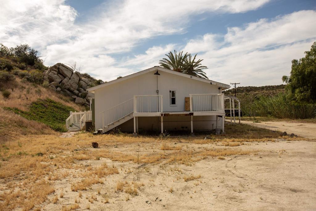 46251 Wilson Valley Road Aguanga, CA 92536 - Photo 4 of 15 a white house that has a tree in front of it