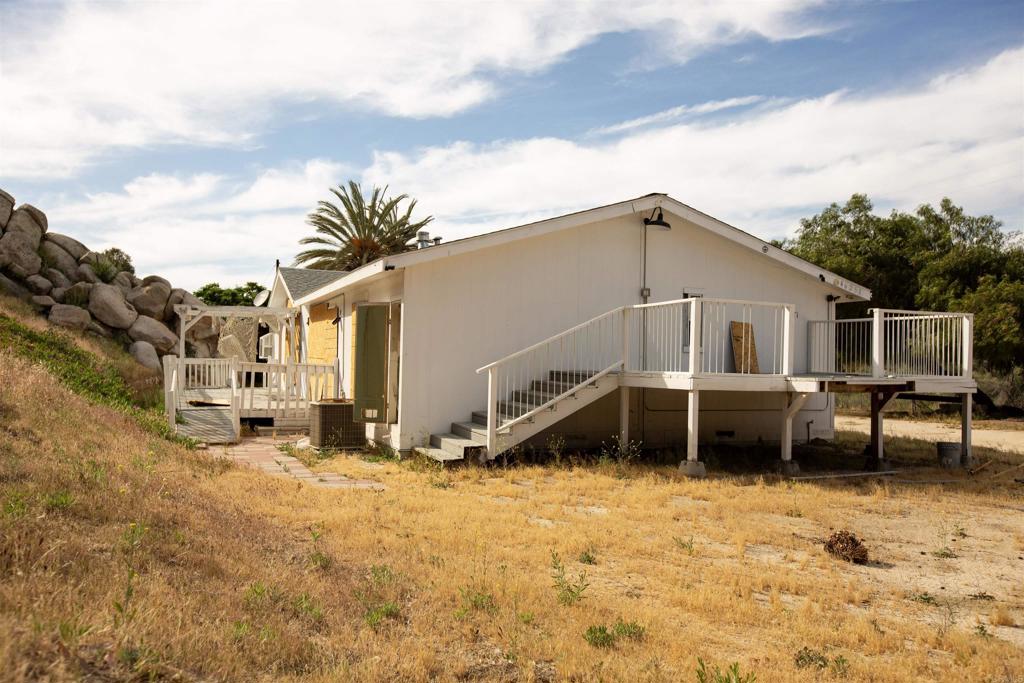 46251 Wilson Valley Road Aguanga, CA 92536 - Photo 5 of 15 a front view of a house with a yard