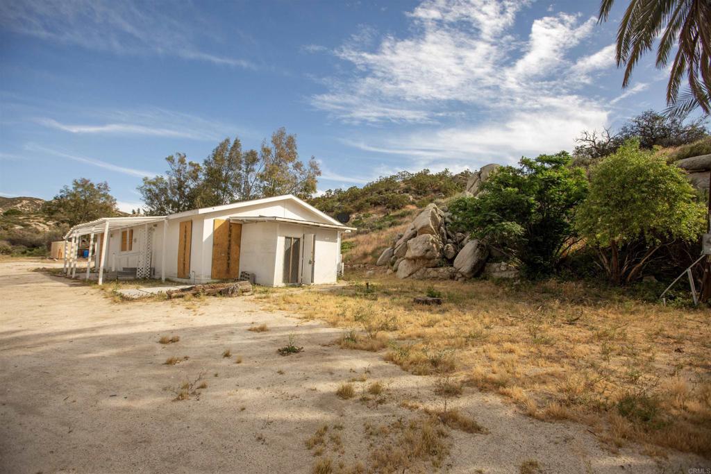46251 Wilson Valley Road Aguanga, CA 92536 - Photo 6 of 15 a front view of a house with a yard