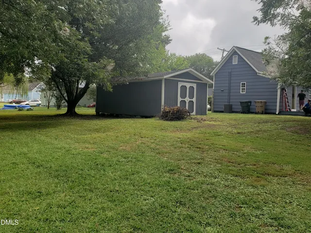 a house with huge green field in front of it
