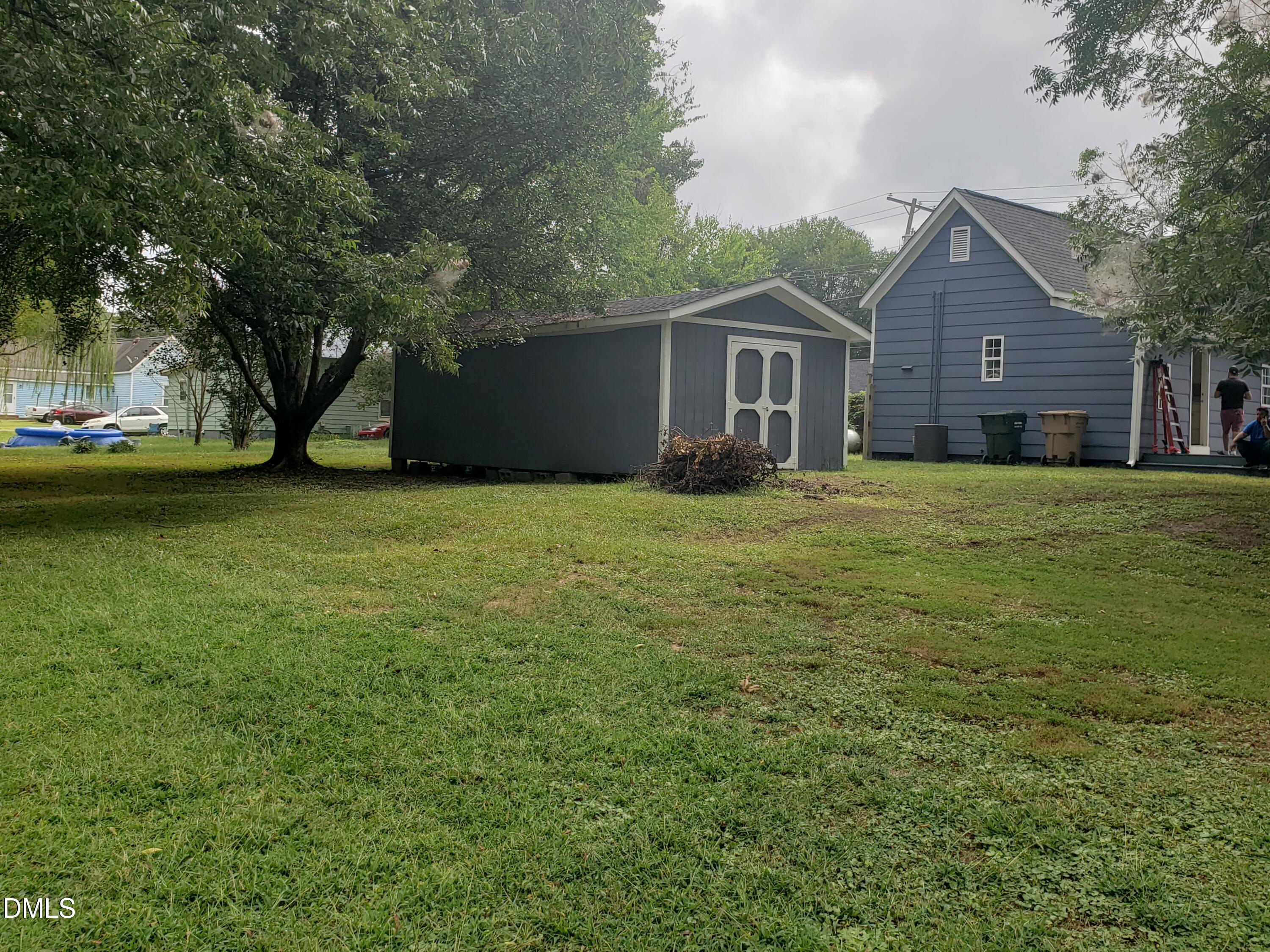 306 South Moore Street Clayton, NC 27520 - Photo 13 of 31 a house with huge green field in front of it