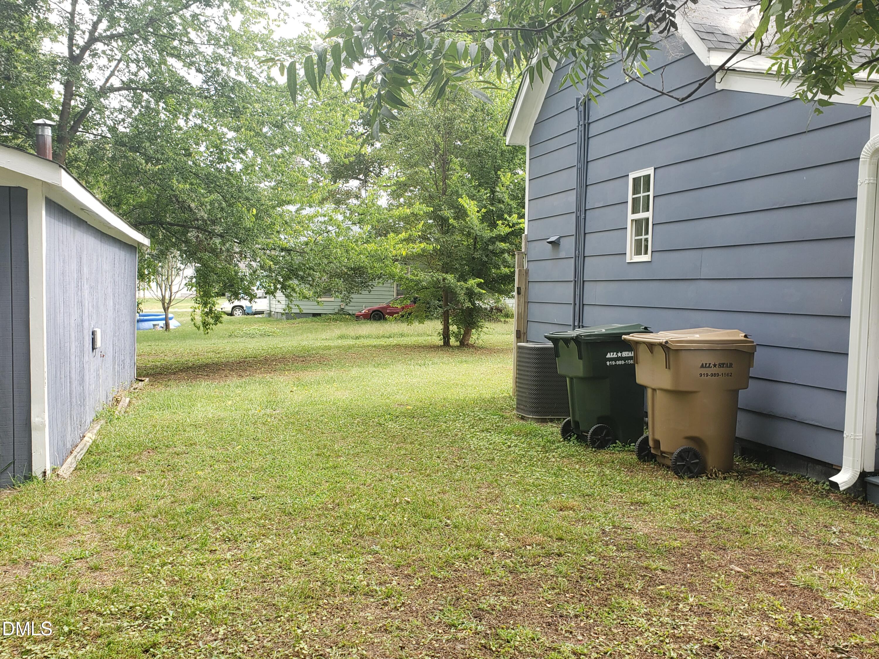 306 South Moore Street Clayton, NC 27520 - Photo 17 of 31 a view of a backyard with plants and garden