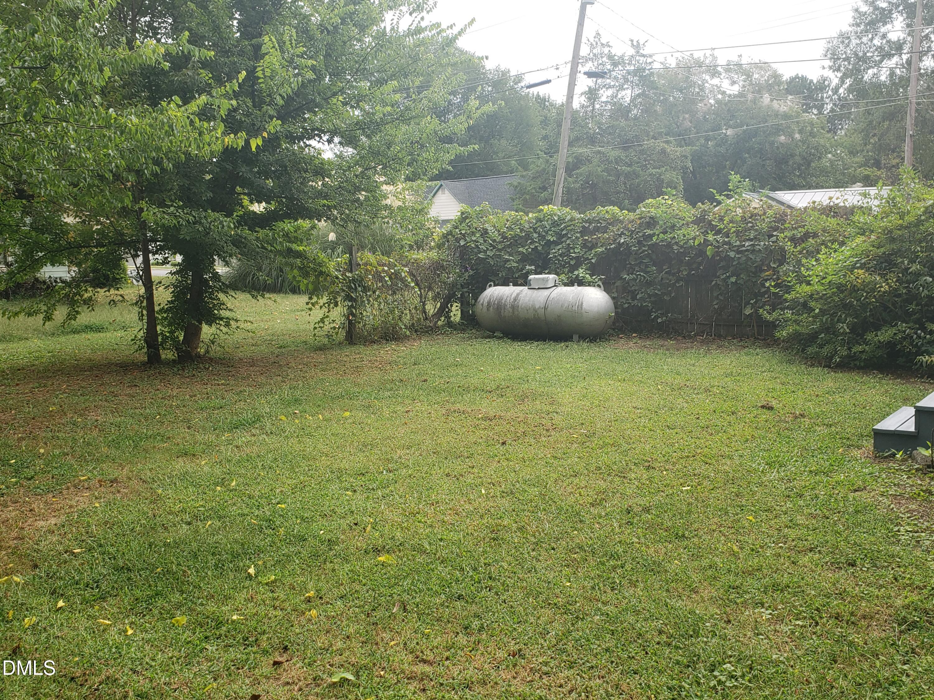306 South Moore Street Clayton, NC 27520 - Photo 18 of 31 a backyard of a house with table and chairs