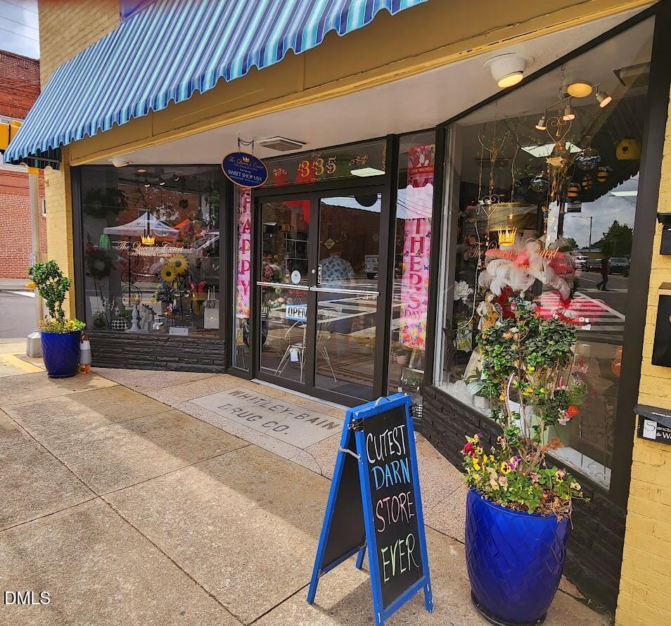 306 South Moore Street Clayton, NC 27520 - Photo 22 of 31 a outdoor view of a shop with garden