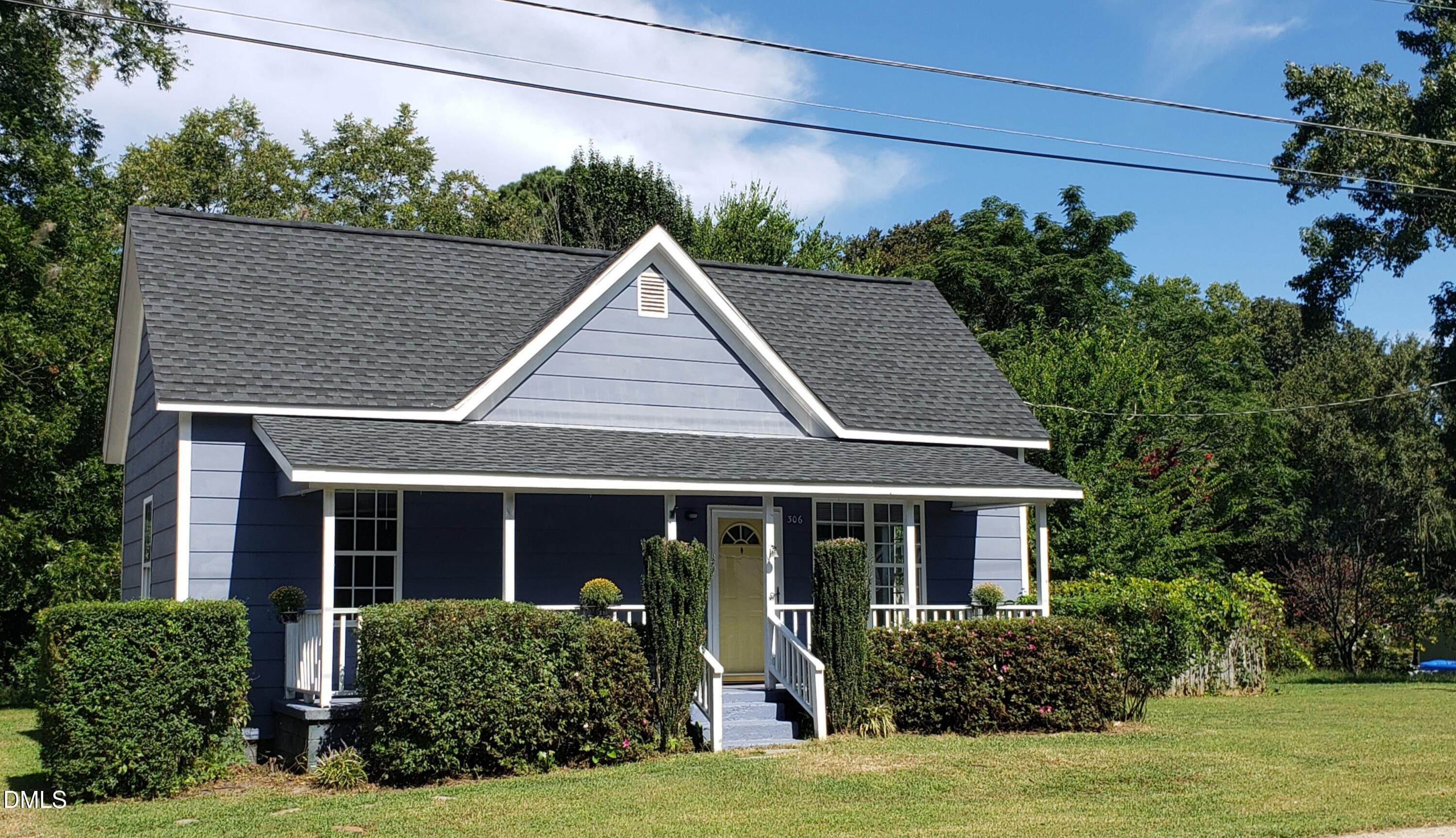 306 South Moore Street Clayton, NC 27520 - Photo 27 of 31 a front view of a house with a yard