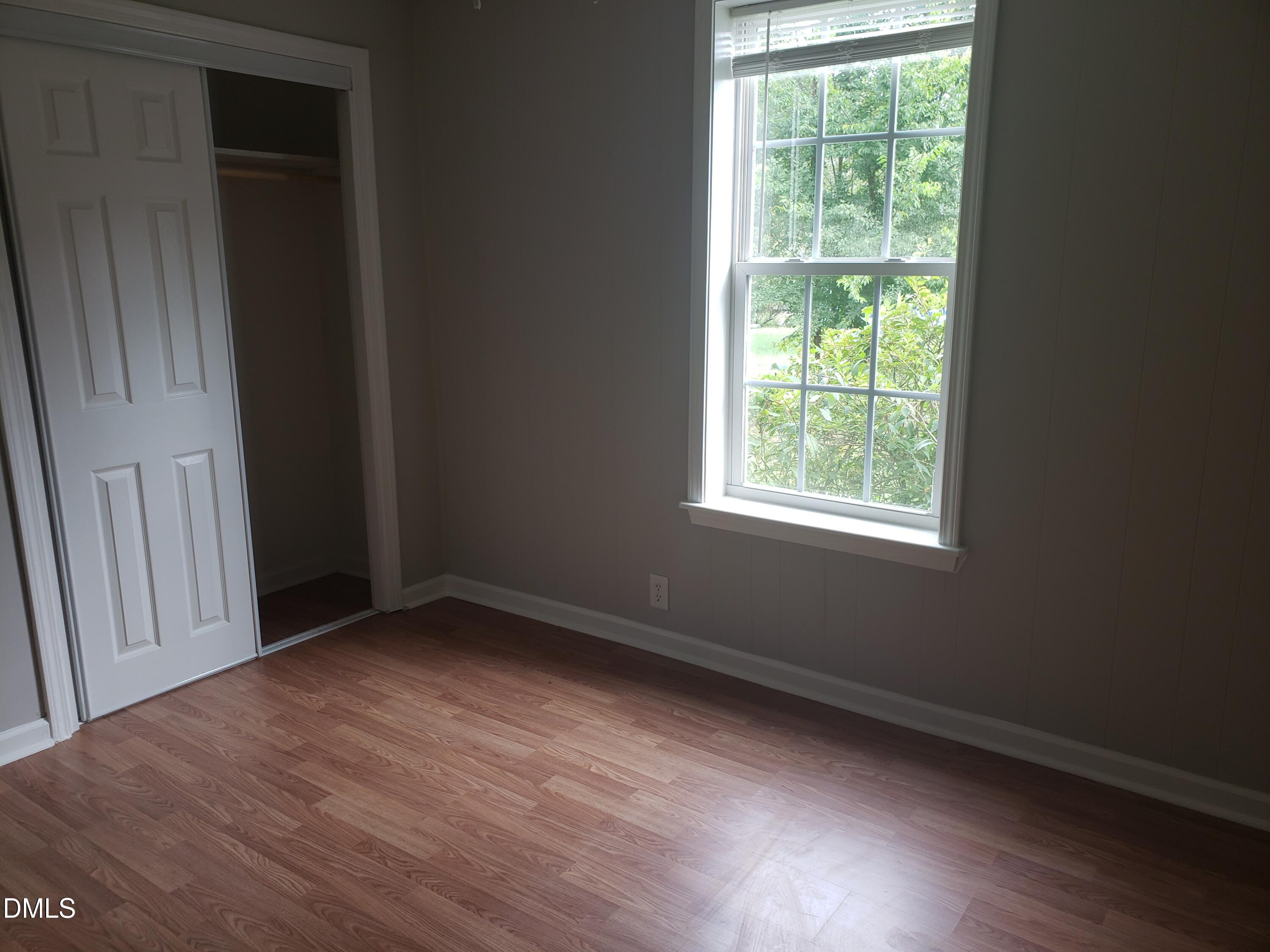 306 South Moore Street Clayton, NC 27520 - Photo 6 of 31 a view of an empty room with wooden floor and a window