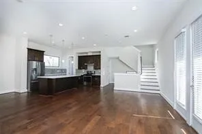 a living room with furniture and kitchen view