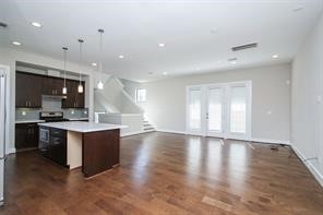 611 Sydnor Street Houston, TX 77020 - Photo 12 of 26 a large kitchen with kitchen island a sink stainless steel appliances and cabinets