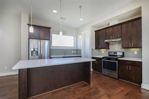 611 Sydnor Street Houston, TX 77020 - Photo 14 of 26 a kitchen with kitchen island granite countertop a sink stove and refrigerator