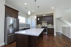 611 Sydnor Street Houston, TX 77020 - Photo 15 of 26 a kitchen with stainless steel appliances a refrigerator sink and stove