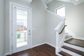 a view of entryway and hall with wooden floor