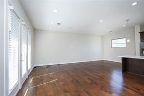 611 Sydnor Street Houston, TX 77020 - Photo 9 of 26 an empty room with wooden floor and windows