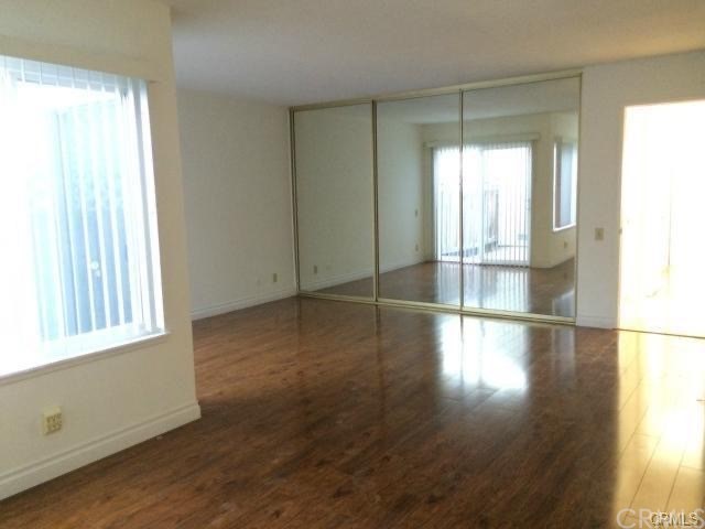 4392 Rafael Street Irvine, CA 92604 - Photo 3 of 6 an empty room with wooden floor and windows