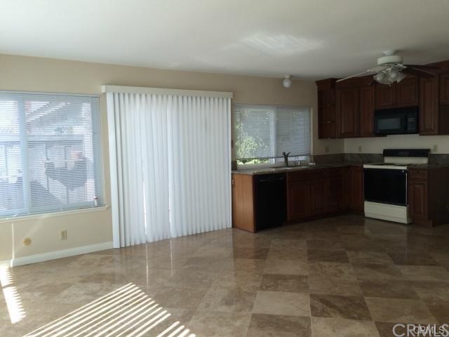 4392 Rafael Street Irvine, CA 92604 - Photo 4 of 6 a kitchen with stainless steel appliances granite countertop a stove a sink and a microwave