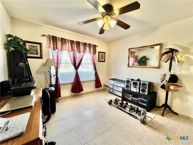 a living room with gym equipment and a flat screen tv