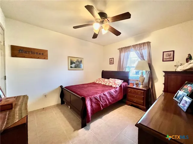 a bedroom with a bed and a couch