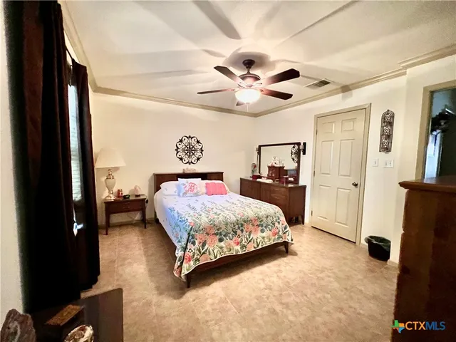 a bedroom with a bed and a large mirror with a flat tv screen