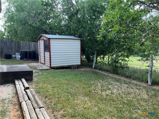 a view of backyard with a garden and deck