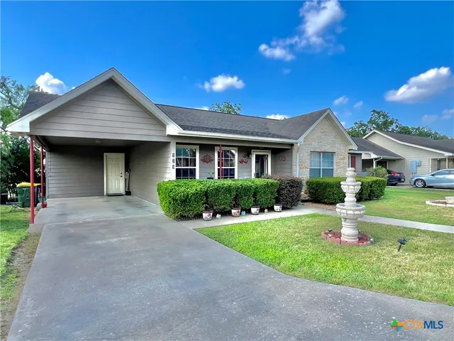 a front view of a house with a yard and porch