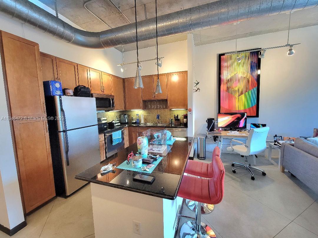 2001 Biscayne Boulevard, Unit 2505 Miami, FL 33137 - Photo 4 of 18 a dining room with furniture and a kitchen view