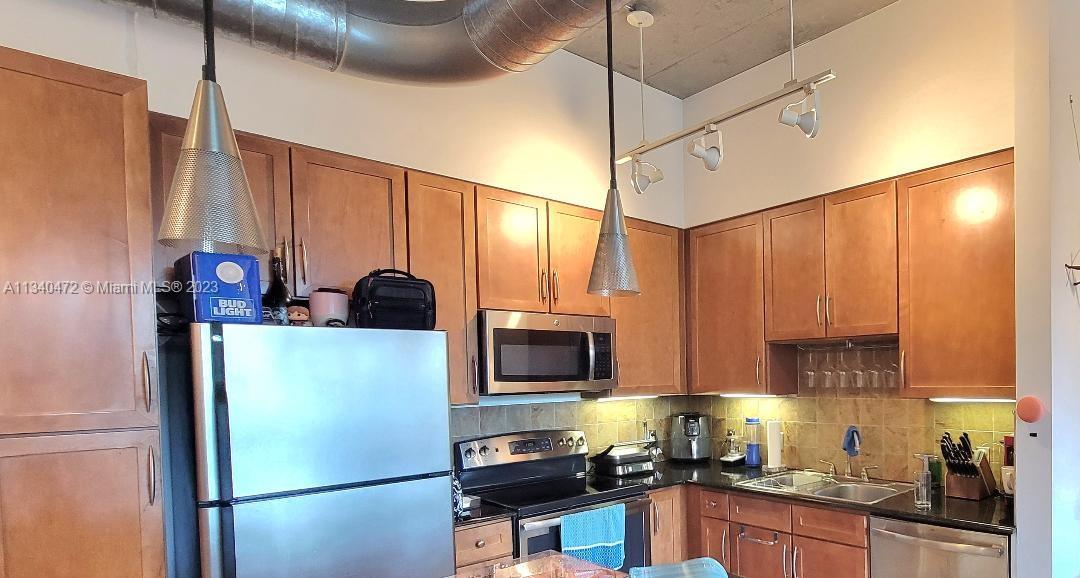 2001 Biscayne Boulevard, Unit 2505 Miami, FL 33137 - Photo 5 of 18 a kitchen with stainless steel appliances granite countertop a refrigerator and a sink