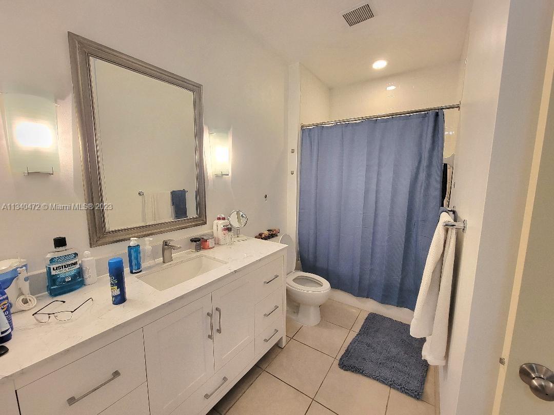 2001 Biscayne Boulevard, Unit 2505 Miami, FL 33137 - Photo 8 of 18 a spacious bathroom with a double vanity sink a mirror and a