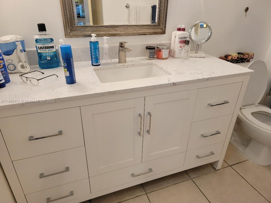 2001 Biscayne Boulevard, Unit 2505 Miami, FL 33137 - Photo 9 of 18 a bathroom with a sink and a mirror