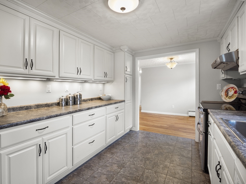 85 Dalton Road Chelmsford, MA 01824 - Photo 11 of 39 a kitchen with granite countertop white cabinets and a stove