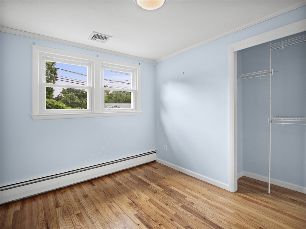 85 Dalton Road Chelmsford, MA 01824 - Photo 15 of 39 an empty room with wooden floor and windows