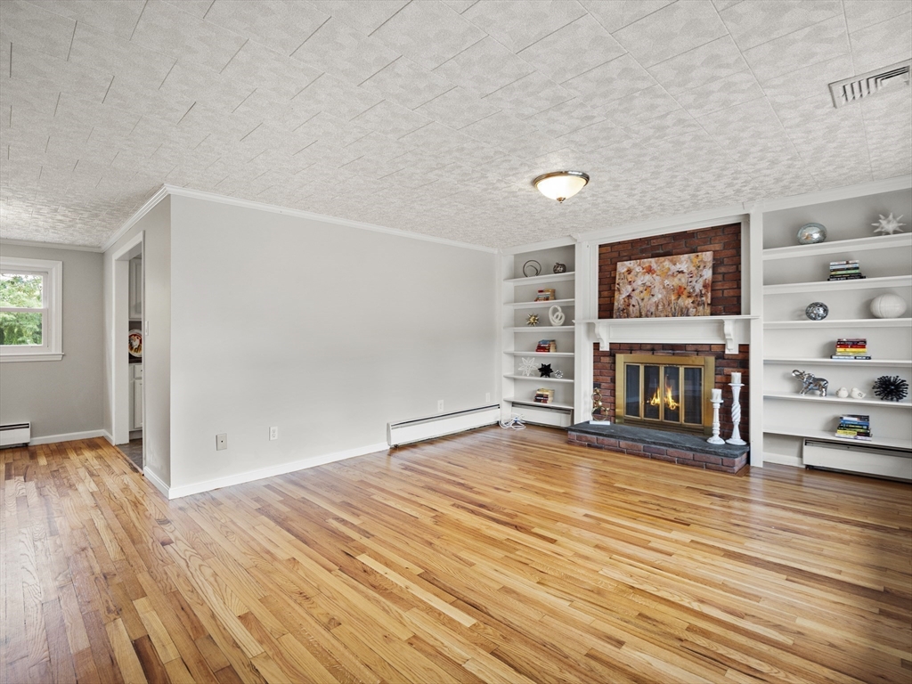 85 Dalton Road Chelmsford, MA 01824 - Photo 4 of 39 a view of an empty room with wooden floor and a window