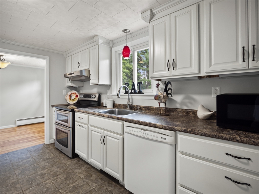85 Dalton Road Chelmsford, MA 01824 - Photo 10 of 39 a kitchen with stainless steel appliances granite countertop a sink dishwasher a refrigerator and white cabinets