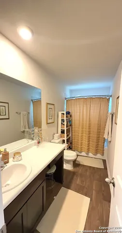 a spacious bathroom with a tub sink and mirror