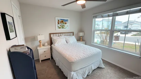 a bedroom with a bed and a window