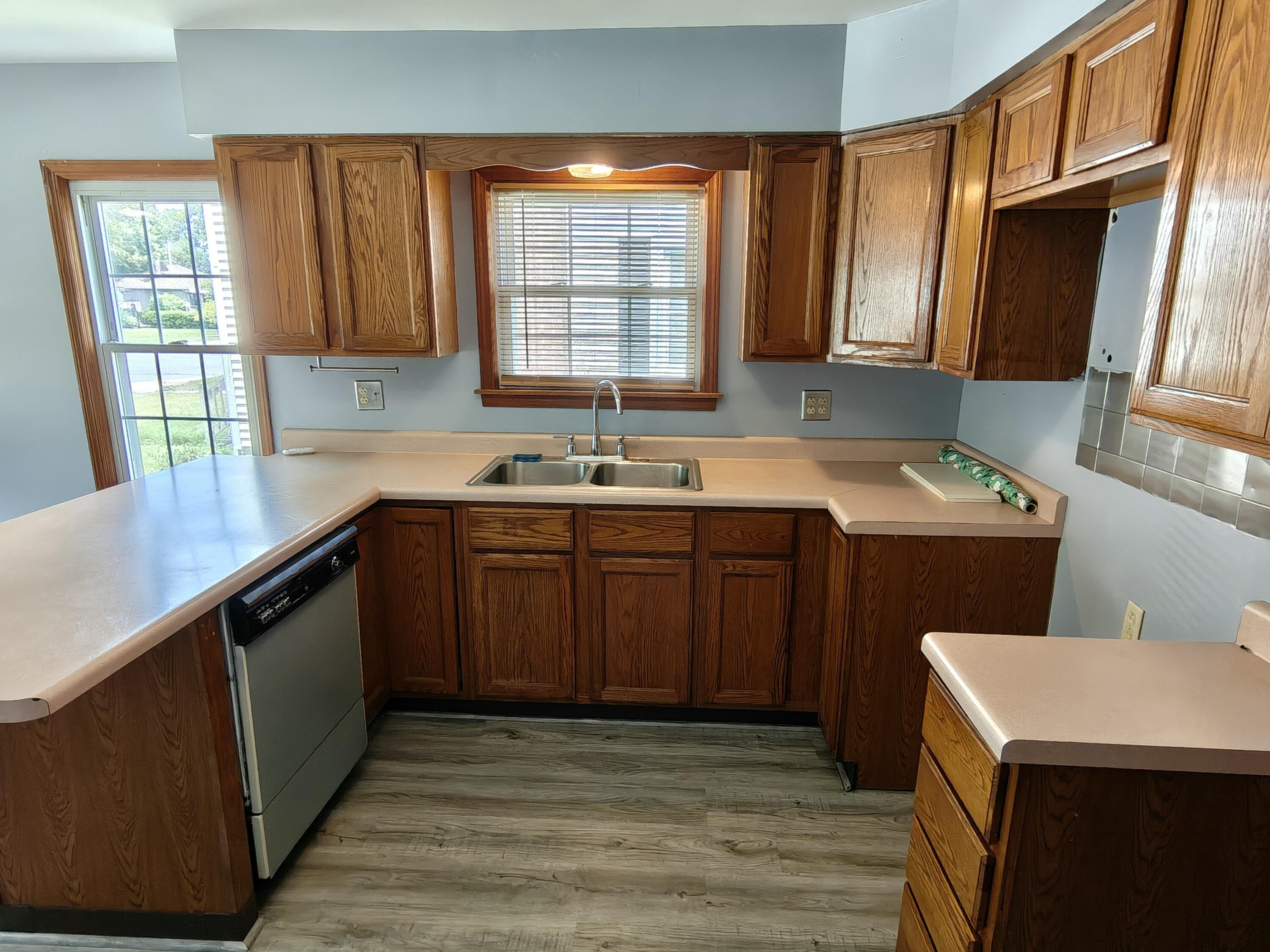 245 North Indiana Street Griffith, IN 46319 - Photo 9 of 30 a kitchen with a sink a window and cabinets
