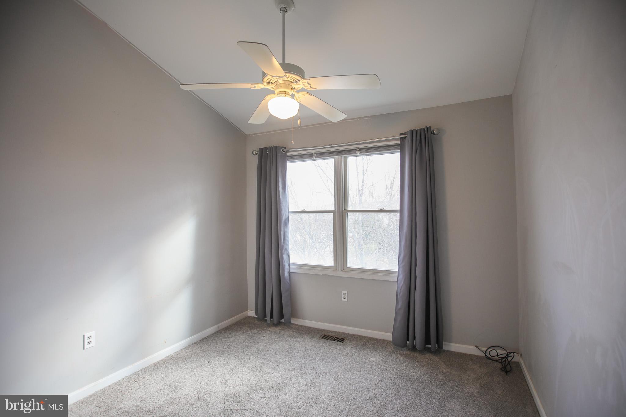 206 Blenny Lane Chester, MD 21619 - Photo 19 of 30 an empty room with windows and fan