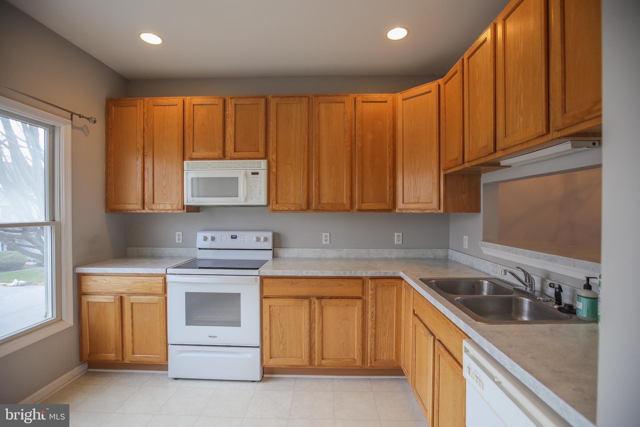 206 Blenny Lane Chester, MD 21619 - Photo 2 of 30 a kitchen with a sink stove and cabinets