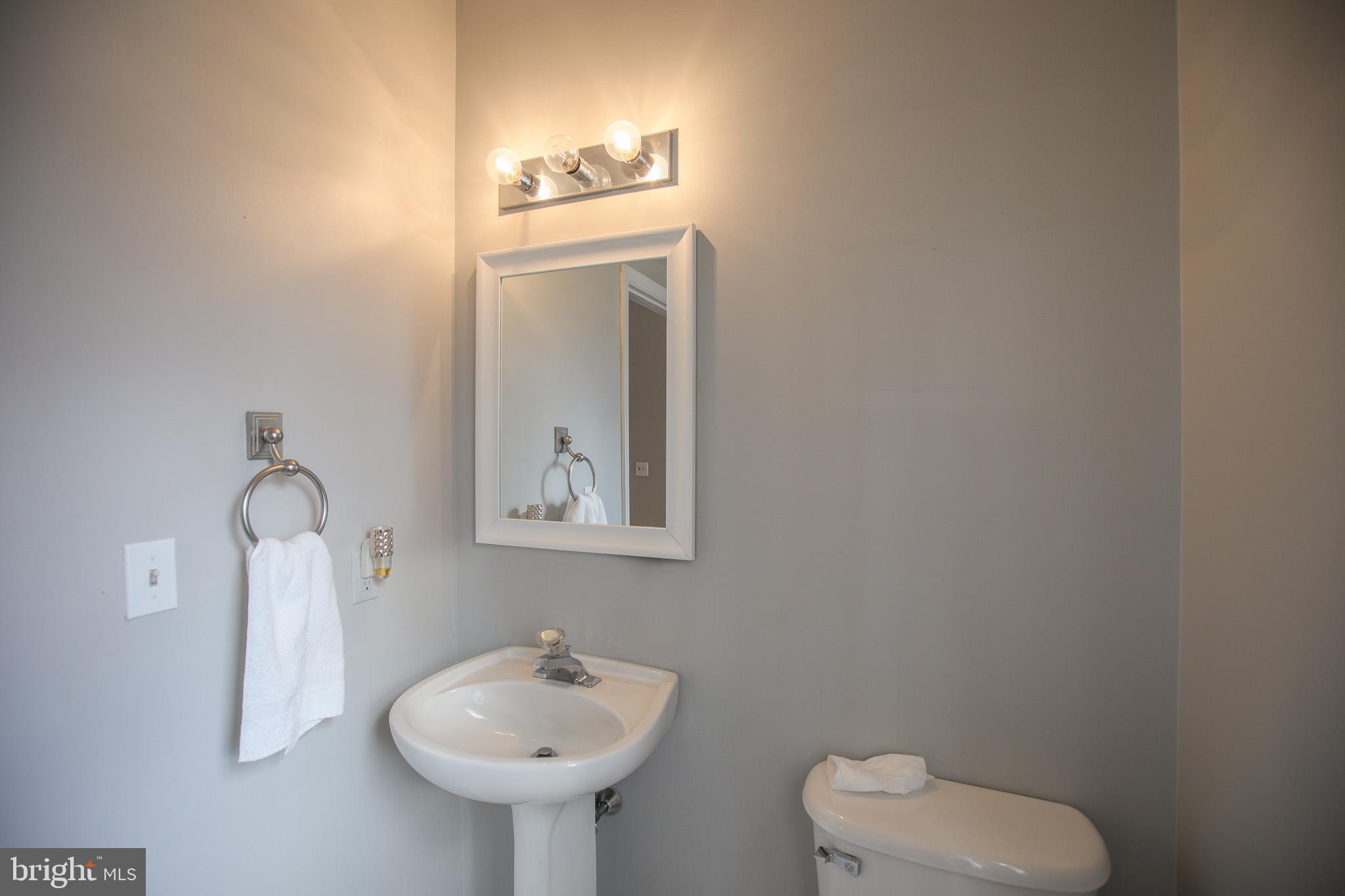 206 Blenny Lane Chester, MD 21619 - Photo 23 of 30 a bathroom with a toilet sink and mirror