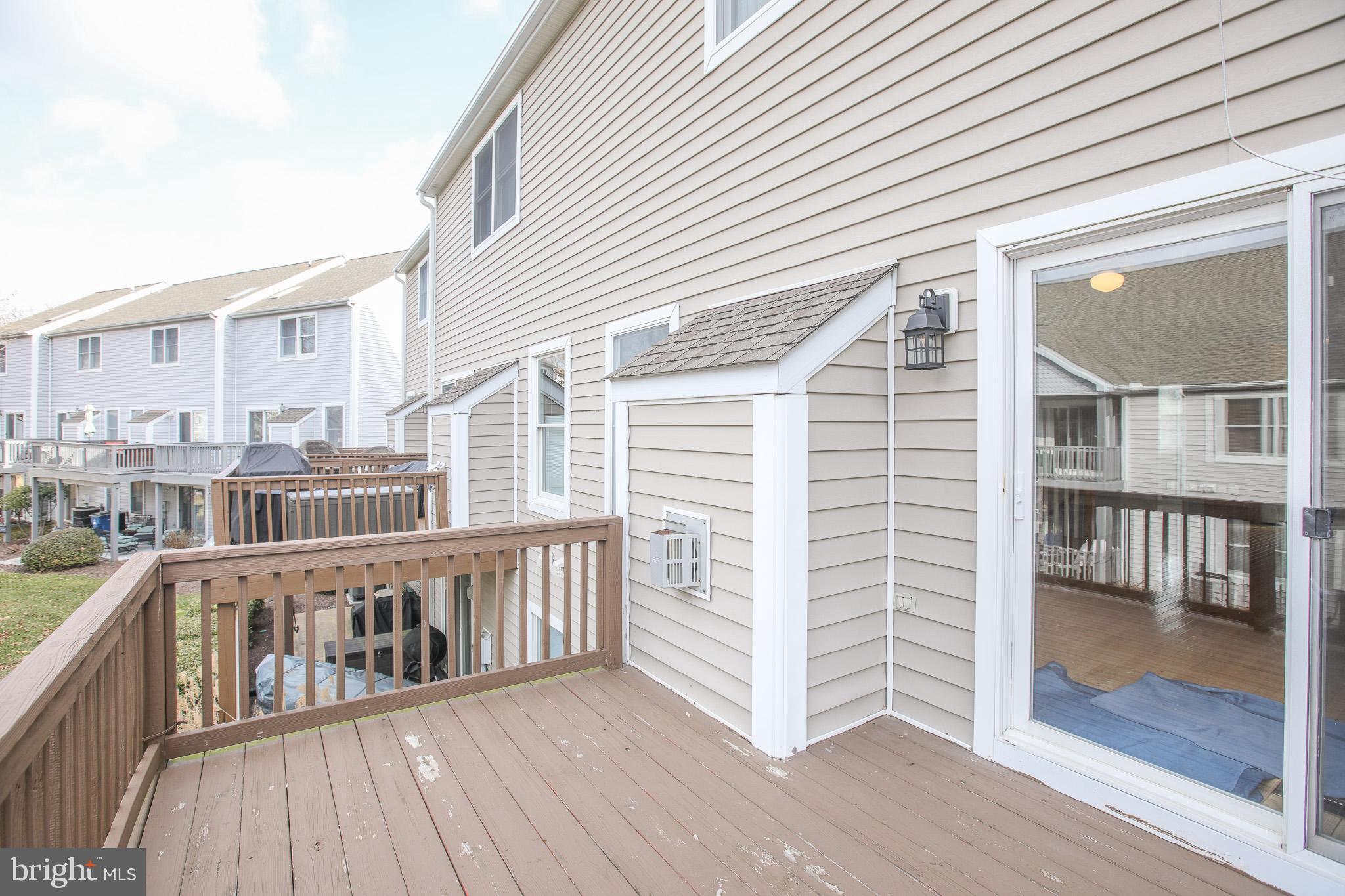 206 Blenny Lane Chester, MD 21619 - Photo 27 of 30 an outdoor view of a house with wooden deck