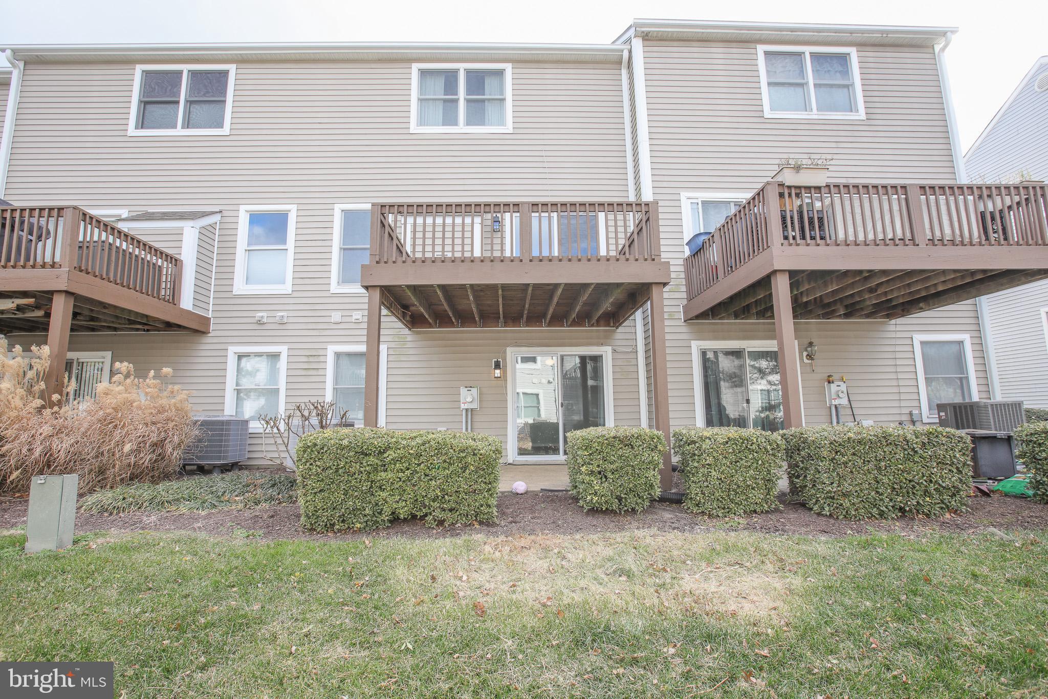 206 Blenny Lane Chester, MD 21619 - Photo 29 of 30 a view of a brick house with large windows and a yard