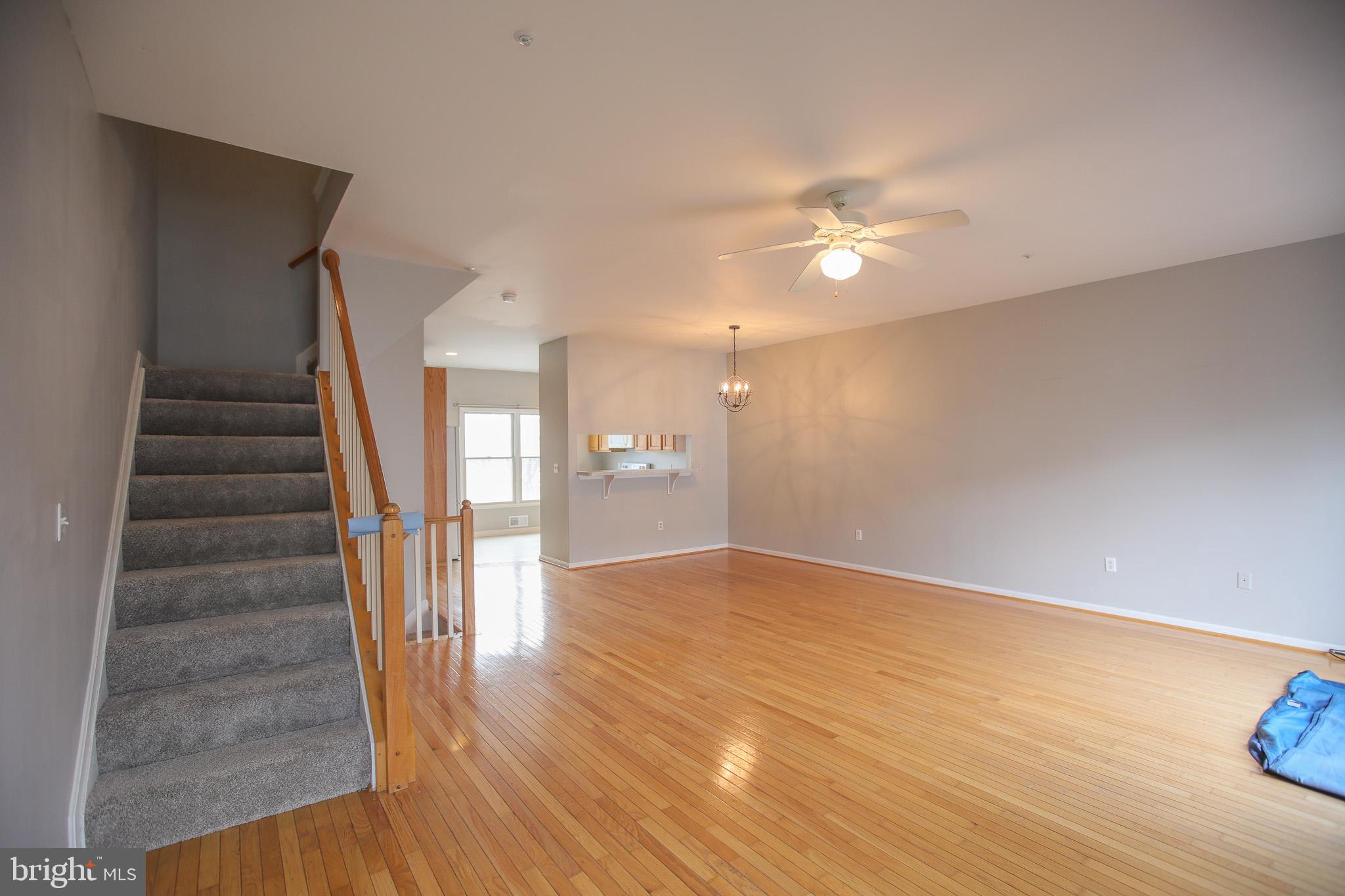 206 Blenny Lane Chester, MD 21619 - Photo 6 of 30 a view of an empty room with wooden floor and a ceiling fan
