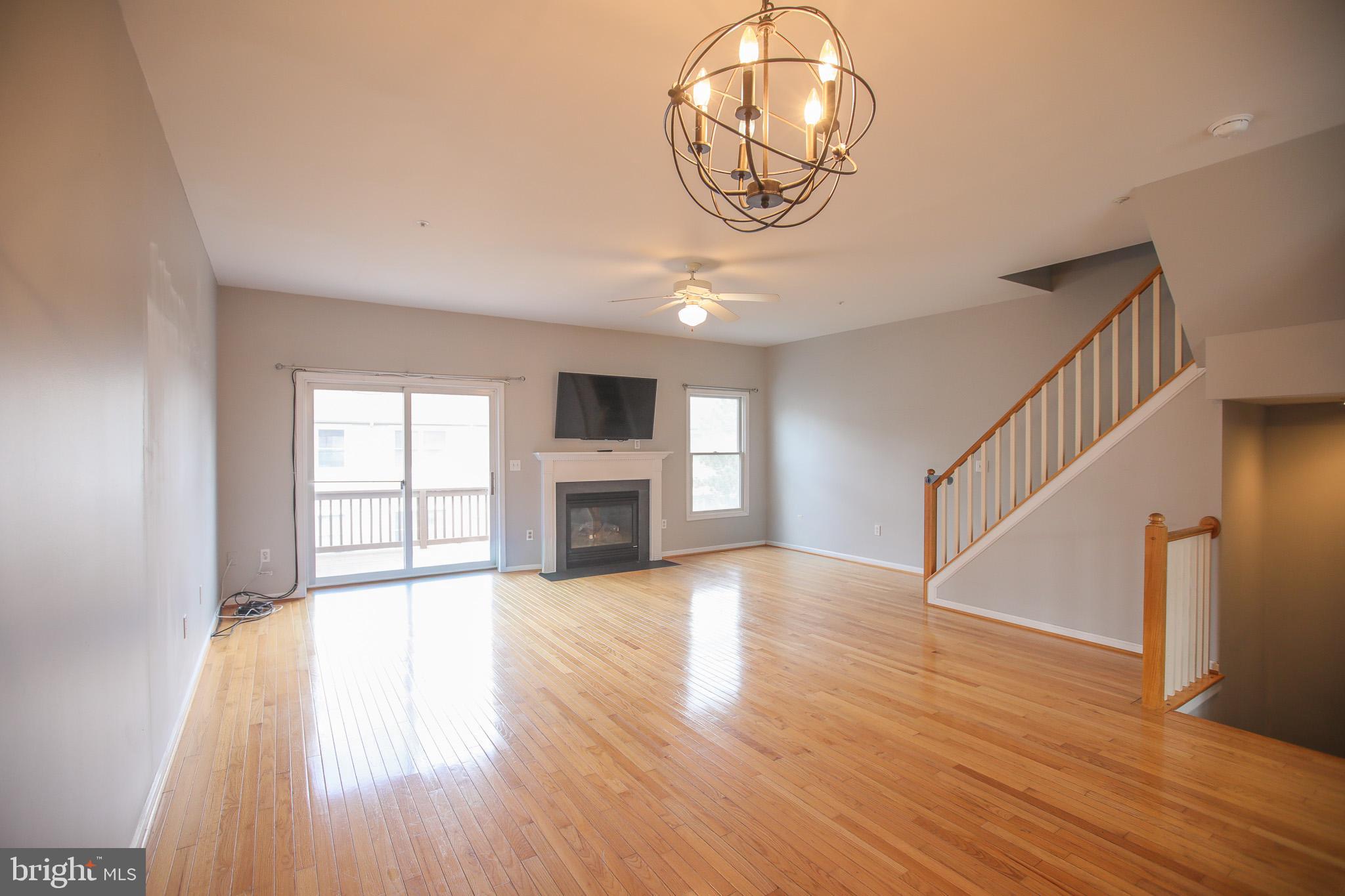 206 Blenny Lane Chester, MD 21619 - Photo 8 of 30 a view of an empty room with wooden floor and a window