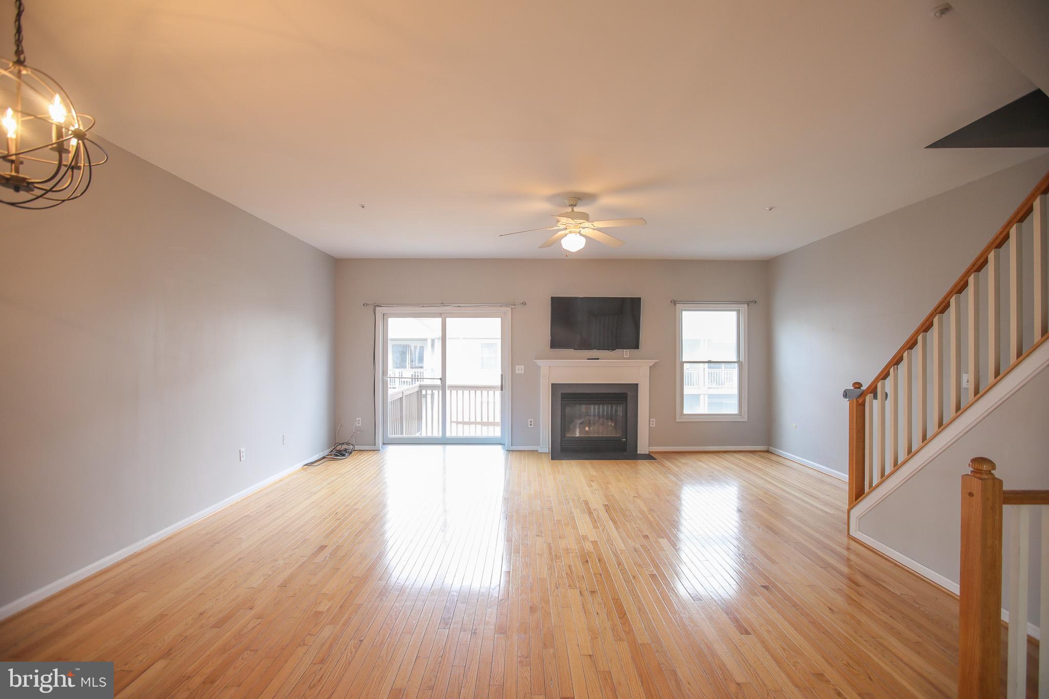 206 Blenny Lane Chester, MD 21619 - Photo 9 of 30 a view of an empty room with wooden floor fireplace and a window